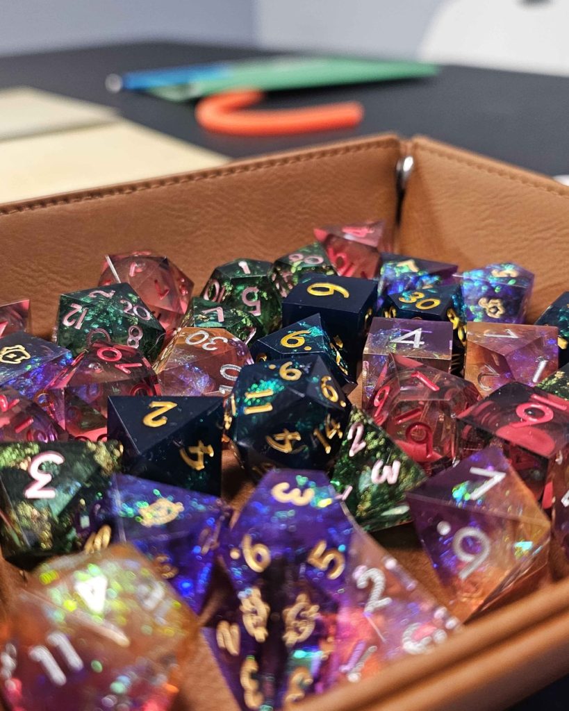 Close-up of colorful polyhedral D&D dice in a leather dice tray