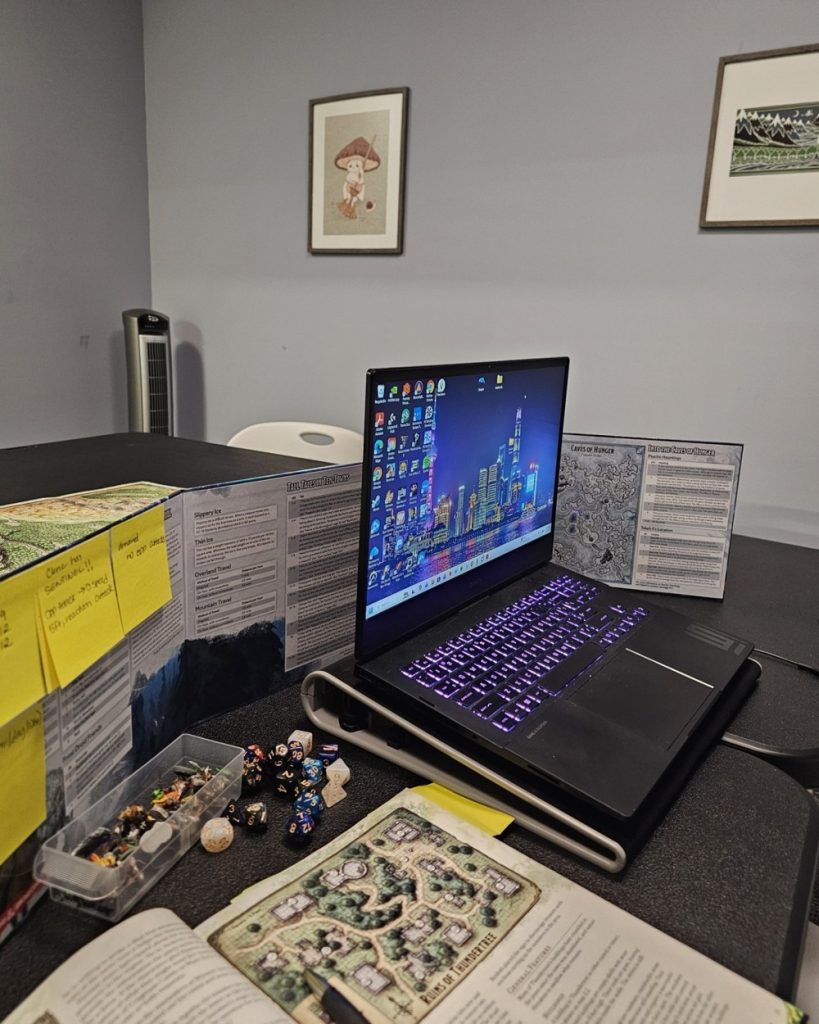 D&D group therapy table setup with GM screen, maps, miniatures and dice